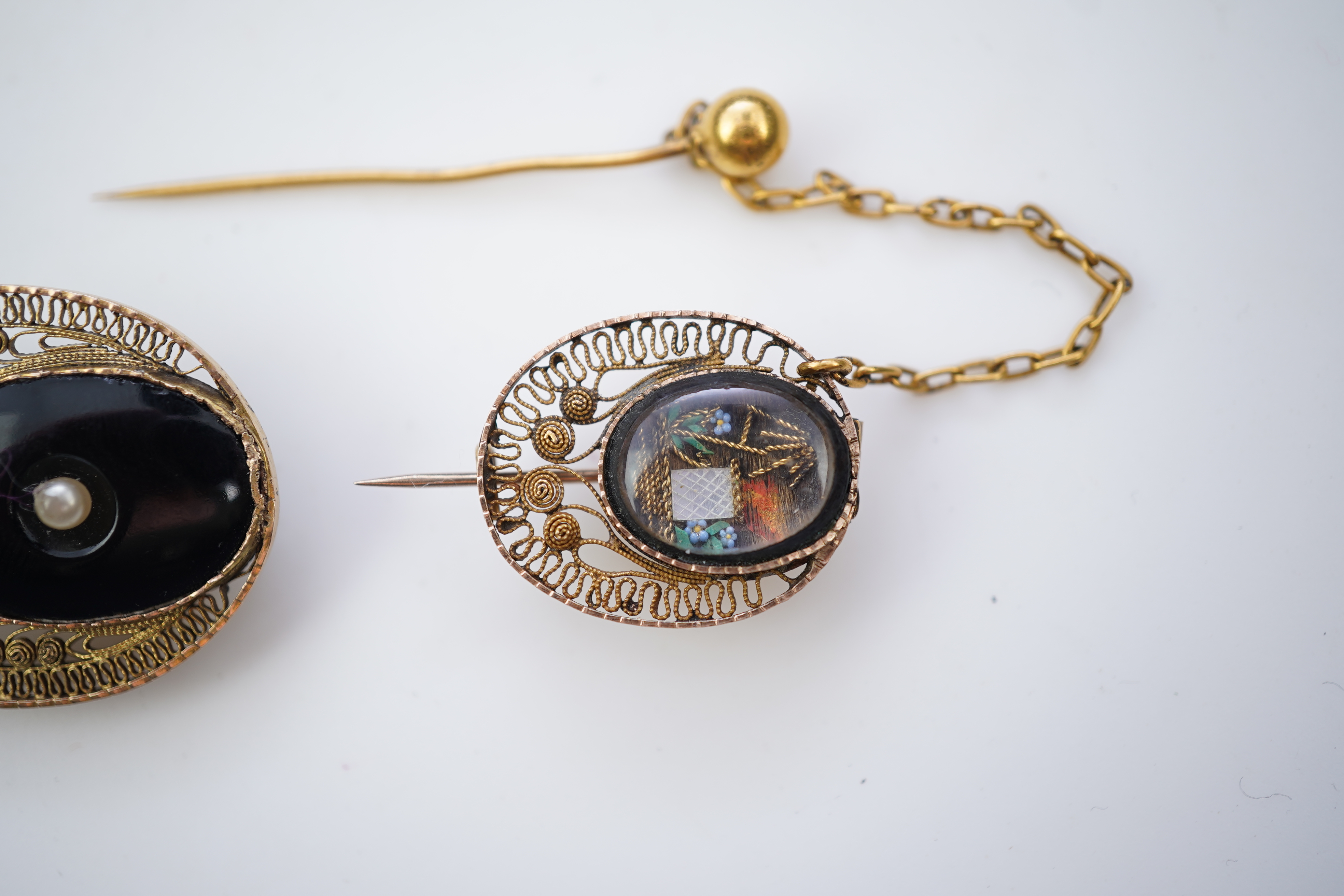 A collection of shell cameo brooches, comprising: a cameo depicting Bacchus, in a gold mount in the Archaeological Revival style, decorated with rope twist and a twisted knife wire border, length 4.4cm; together with sev